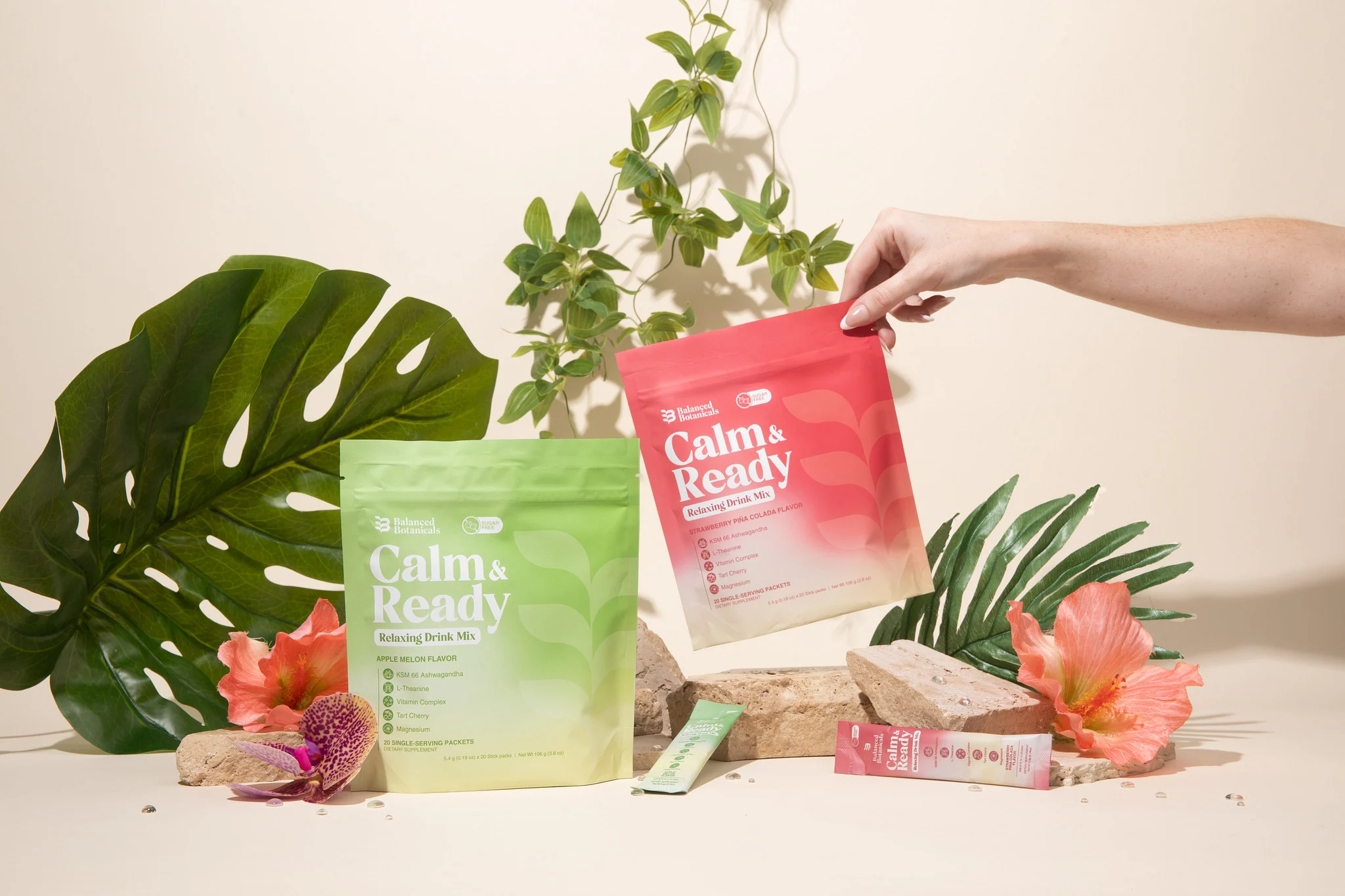 Colorful overlay on calming drink mix packages with plants in the background.